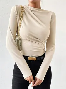 Detailed view of women's beige long sleeve ruched bodysuit with elegant drape design