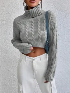 Detailed view of the gray cable-knit cropped sweater with a high turtleneck design.