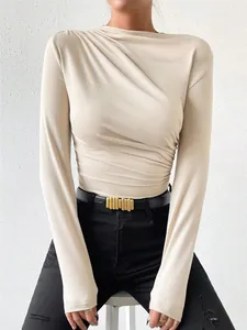 Detailed macro view of beige long sleeve slim bodysuit featuring elegant pleated draped design