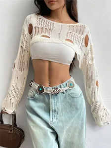 Close-up of white distressed crochet knit shrug showing intricate hollow-out details