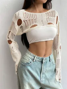 Detailed macro view of white distressed crochet knit shrug showing textured hollow patterns