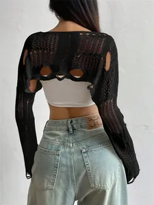 Detail view of the back of a black distressed open-knit cropped shrug with hollow design