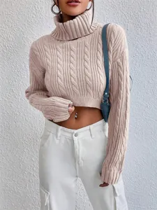 Fashion model wearing a beige cable knit cropped turtleneck sweater with white cargo pants