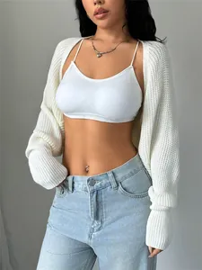 Close-up detail of white chunky knit cropped cardigan shrug with extra long sleeves
