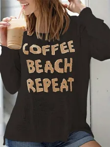 Detail shot of women's casual side-slit knit sweater featuring Coffee Beach Repeat text