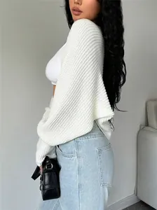Side view of a stylish white loose-knit short shrug cardigan with drop shoulder detail.