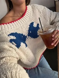 Close-up of vintage colorblock jacquard knit sweater with red trim and white chunky knit
