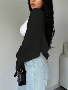 Close-up side view showing the texture of a black cropped knit shrug shawl cardigan