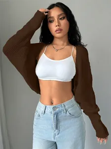 Fashionable brown cropped knit cardigan shrug shown on model with light blue jeans.