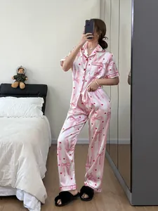 Pink striped pajama set with red heart and bow print detail, comfortable lounge wear view.