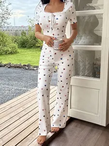 Two-piece white heart print pajama set featuring lace trim and ribbed fabric texture