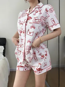 Detail view of white short-sleeved pajama set with red heart and wine glass print.