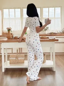 Back view of women's white loungewear set with multi-colored heart print and short sleeves