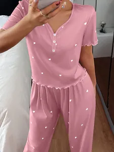 Close-up detail of pink ribbed short-sleeve pajama set featuring sweet heart patterns