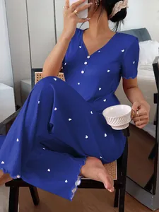 Women's blue ribbed pajama set with white heart print shown in a cozy loungewear lifestyle shot