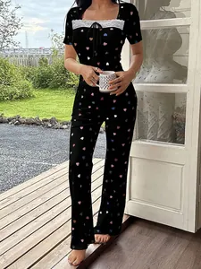 Detailed view of women's heart print pajama set with elegant white lace neckline trim.