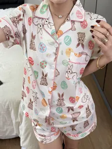 Close-up detail of women's summer Easter bunny and egg print pajama set with pink piping.