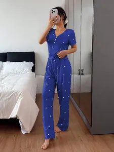 Blue ribbed two-piece pajama set with white heart print worn by a model in bedroom