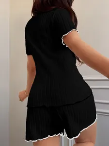 Back view of women's black ribbed loungewear set with white scalloped trim details.