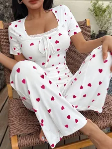 Close-up of the white heart print pajama set with lace trim and bow knot detailing