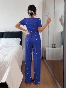 Back view of blue short-sleeved ribbed pajama set with white heart patterns for women