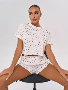 Comfortable two-piece white pajama set featuring red heart print and lettuce edges.