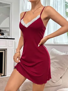 Close-up view of a burgundy ribbed slip dress featuring white lace trim and skinny straps.
