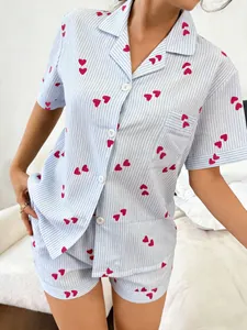 Detail view of women's blue striped short-sleeved pajama set with red heart pattern