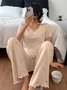 Full view of women's ribbed heart print pajamas worn by model in a bedroom setting