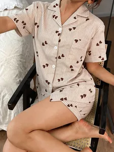 Detail view of heart-patterned striped pajama set with lapel collar and short sleeves.
