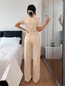 Cozy back view of a ribbed short sleeve pajama set with heart prints in a bedroom