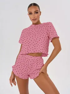 Pink two-piece loungewear set with red heart print, short sleeves and comfy shorts