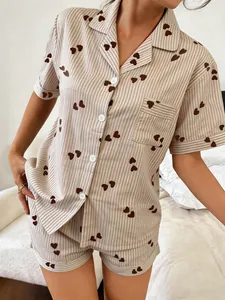 Close-up detail of striped pajama set with brown heart prints on short-sleeve shirt
