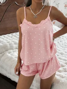 Detailed view of pink heart print ribbed camisole and shorts pajama set on a model