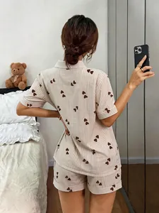 Back view of women's short sleeve pajama set with heart and stripe pattern print