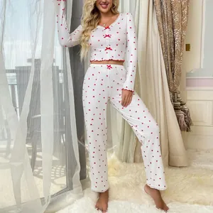 Women's two-piece white pajama set featuring red heart patterns and decorative bows