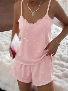 Close-up of pink heart-patterned ribbed pajama set featuring elegant lace trim details