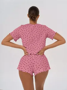 Detailed back view of a pink cotton pajama set featuring a delicate heart print