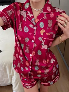 Detail view of red satin pajama set with cartoon bunny and Easter egg pattern