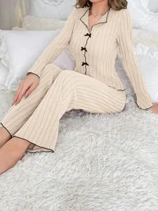 Close-up of elegant ribbed two-piece pajama set with black trim and bow details
