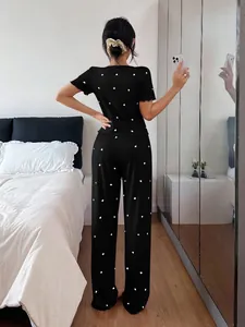 Detailed back view showing the fit and ribbed texture of the black heart print pajamas.
