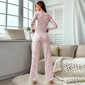 Elegant pink floral two-piece pajama set with long sleeves and ruffled hem pants