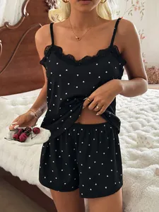 Detail view of heart-print lace trim pajama set on model in cozy bedroom