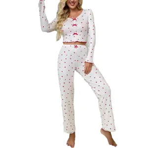 Stylish women's white two-piece pajama set with red heart print and ruffled edges
