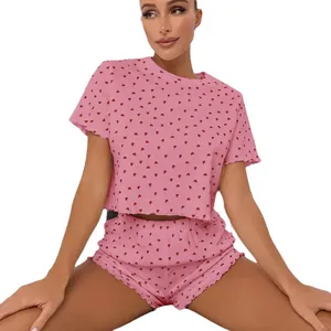 Pink heart print two-piece pajama set with short sleeves and ruffled shorts for women
