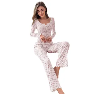 Floral print two-piece pajama set with long sleeves, lace collar and button detail.