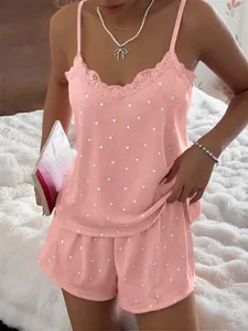 Close-up of pink ribbed pajama set featuring delicate lace trim and heart pattern