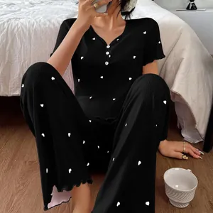 Comfortable women's black ribbed pajama set with short sleeves and heart print pants