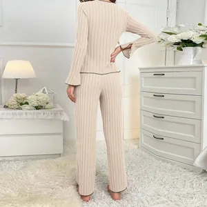 Elegant women's cream ribbed long-sleeve pajama set featuring stylish ruffle cuffs