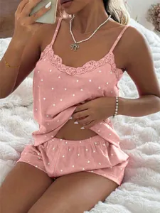 Detail of pink heart-patterned rib-knit pajamas with delicate lace trim on the camisole.